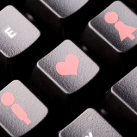 Man, woman, and heart icons on a computer keyboard